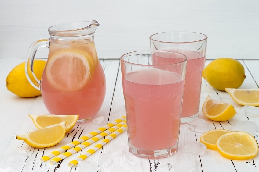 pink lemonade in a jug and glasses