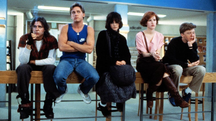The Breakfast Club cast sitting in the library looking bored