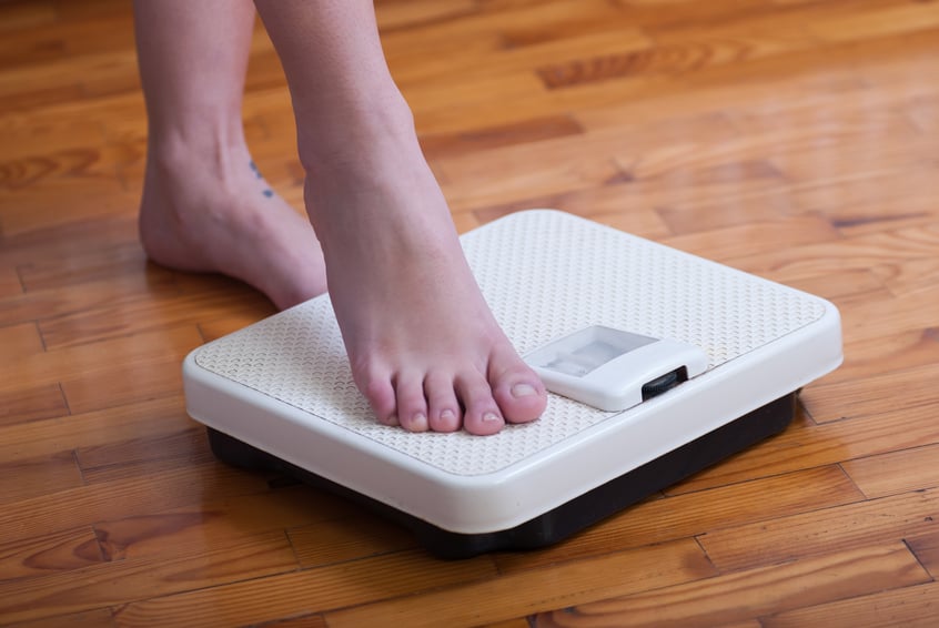 Womans feet on weighing scale