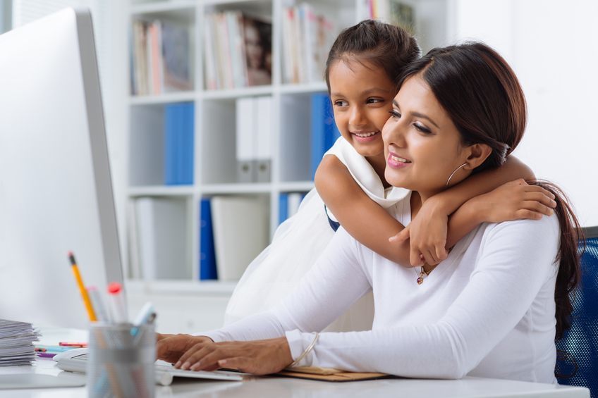 Mother with child in front of computer