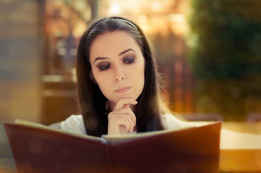 Woman reading restuarant menu