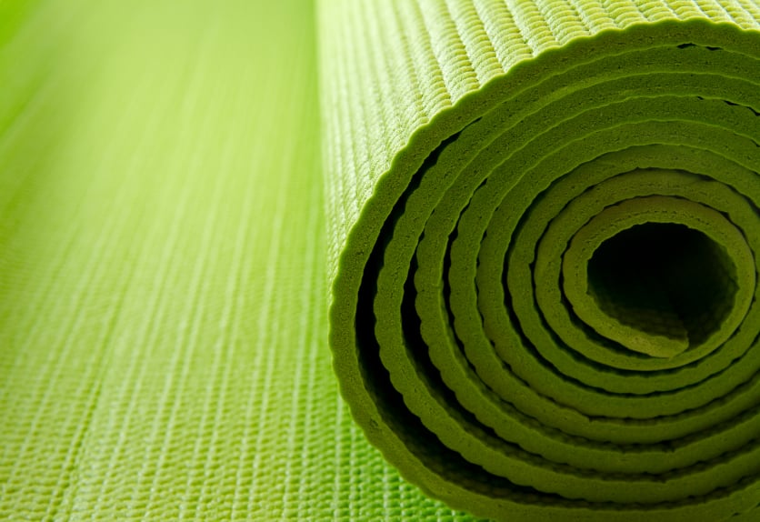 close-up of a partially rolled yoga mat