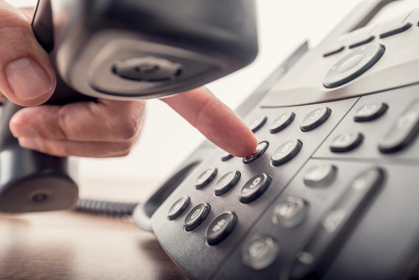 male hand holding telephone receiver