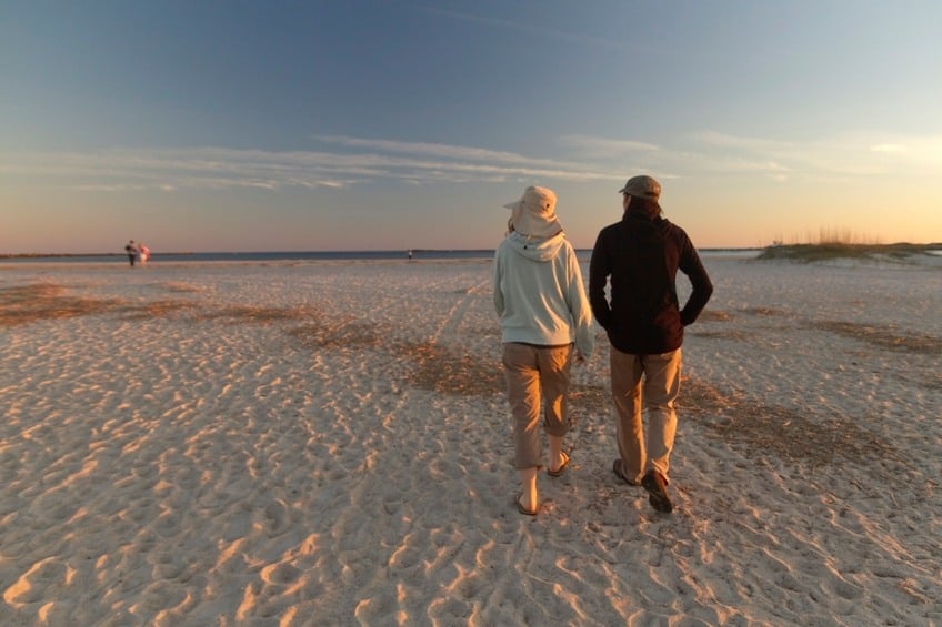 a couple walking on the beach