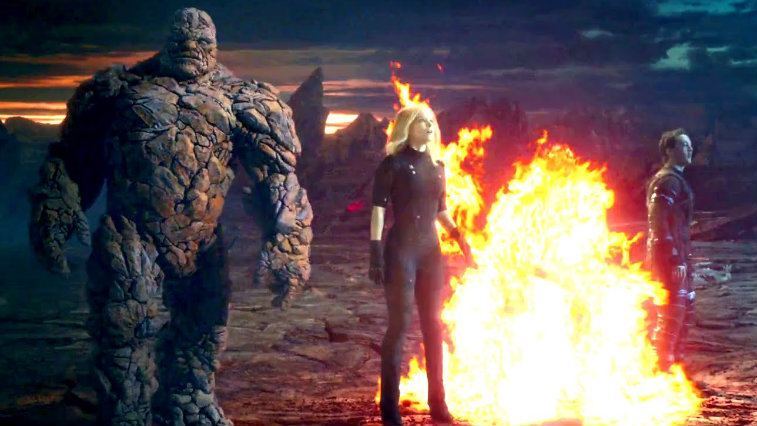 The Thing, Invisible Woman and Mr. Fantastic stand around a blazing fire in Fantastic Four