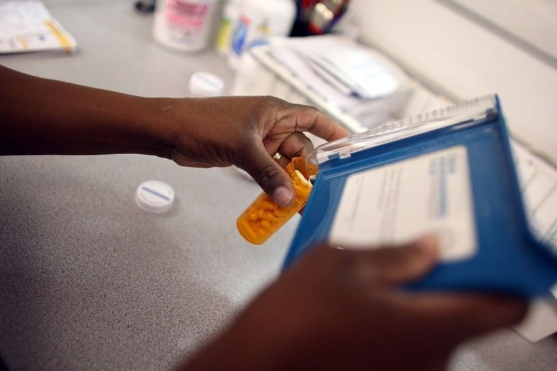 Rosemary Petty, a Publix Supermarket pharmacy technician, counts out a prescription of antibiotic pills