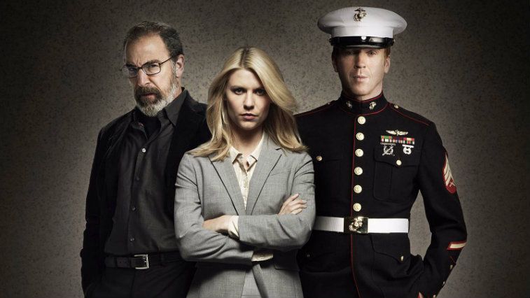 Homeland's Saul, Carrie, and Brody pose in front of a grey background