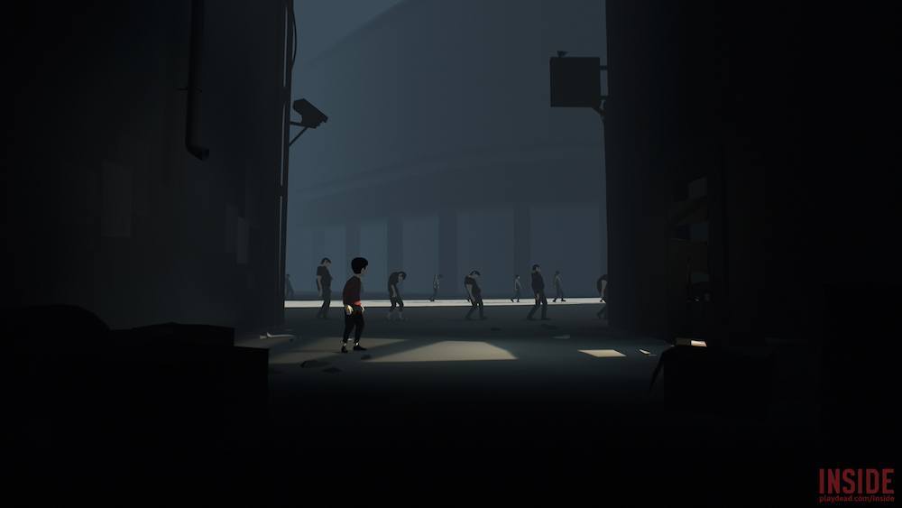A boy sneaks through a facility.