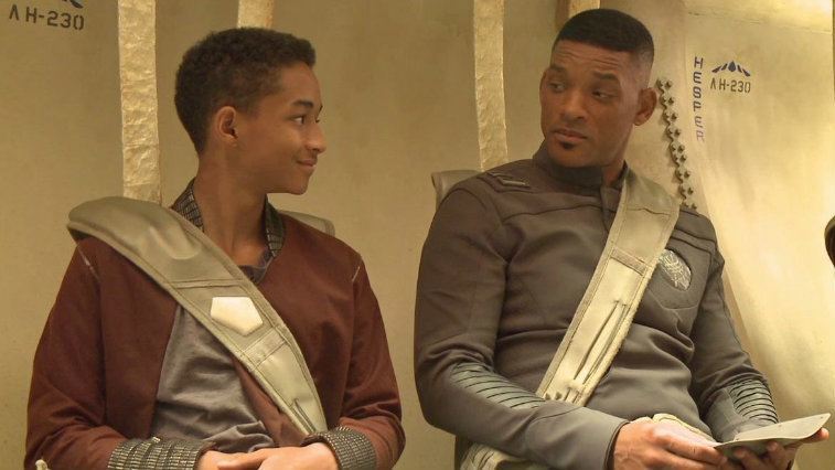 Jaden Smith and Will Smith look at each other as their strapped into seats in After Earth.