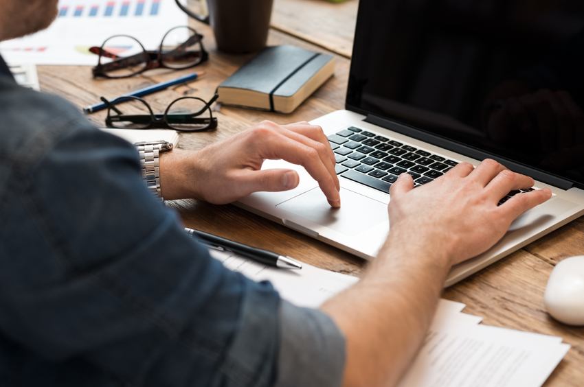 man working on laptop on office desk