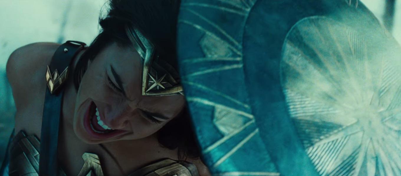 Wonder Woman fights while hiding behind her sheild