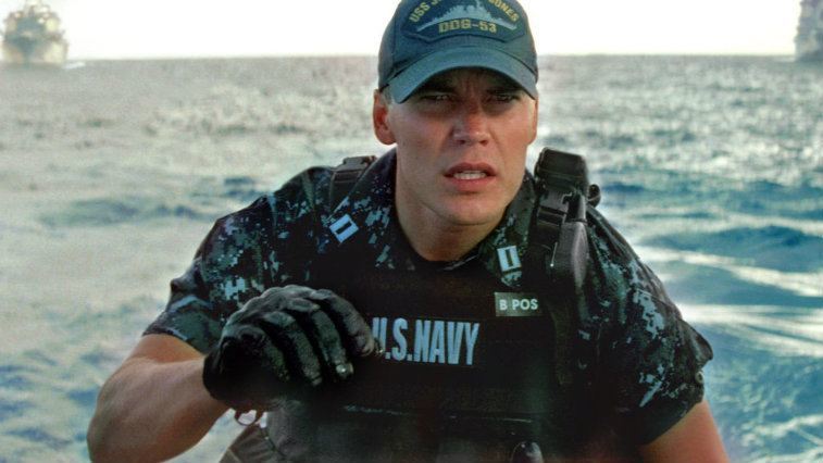Taylor Kitsch stands in a navy uniform in Battleship