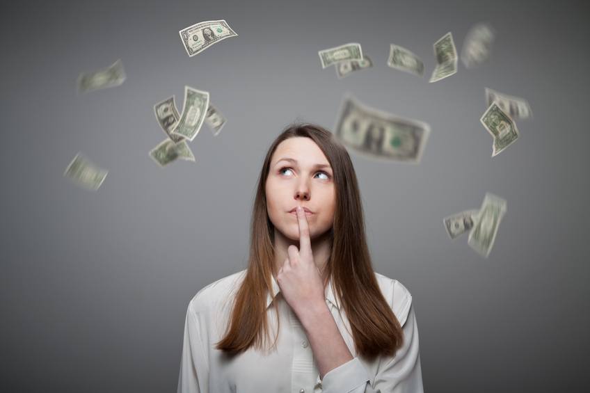 Young woman thinking about paying bills