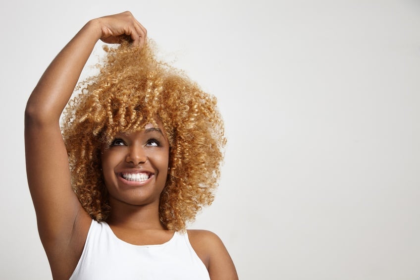 black woman looking at her hair