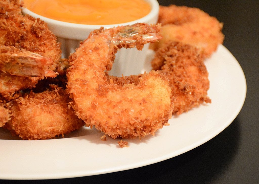 detail of crispy coconut shrimp served with mango sauce