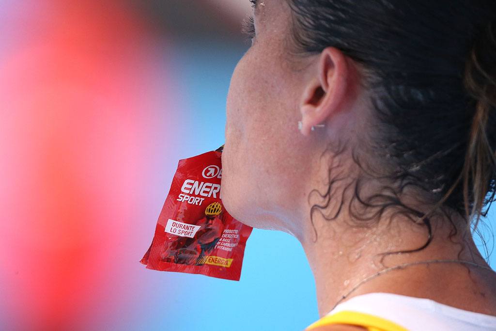 athlete eating an energy gel at the Australian Open