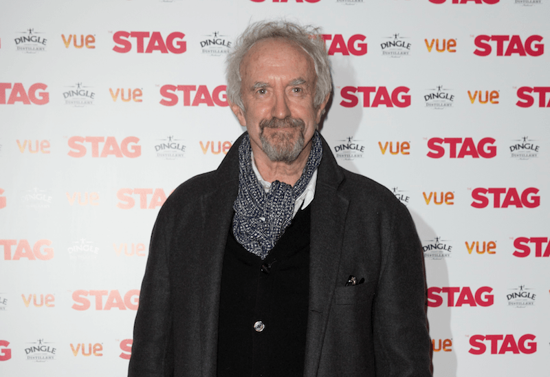 Jonathan Pryce poses for cameras at an event