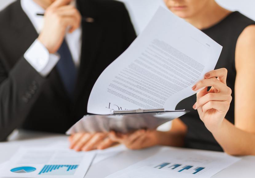 Two people review a contract.