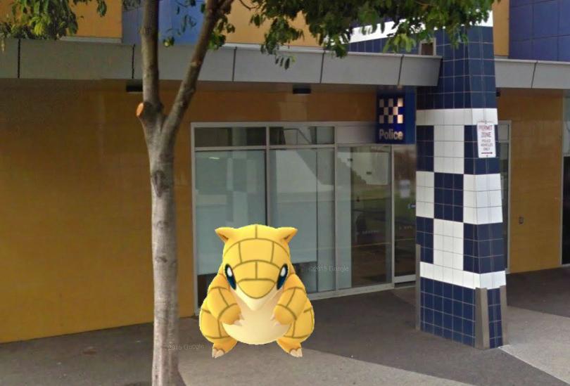 A Sandshrew Pokemon sits at a police station.