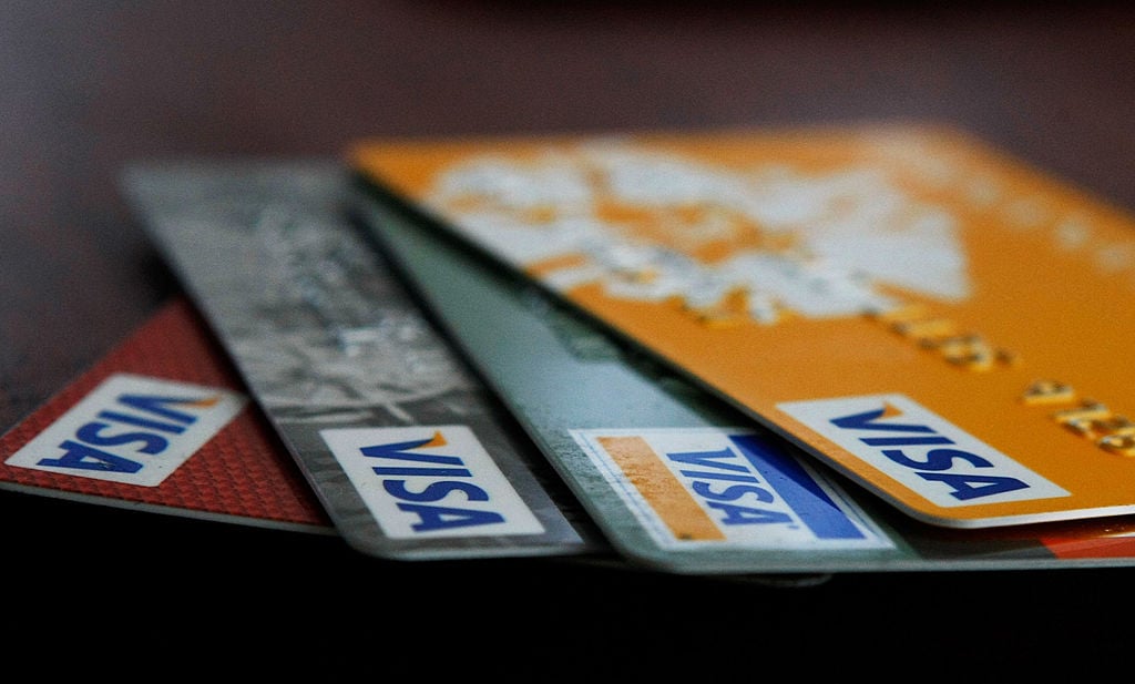 Visa credit cards are arranged on a desk
