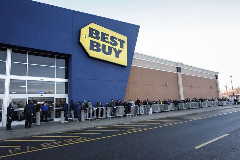 A Best Buy Employee opens the door to Customers for Black Friday Sales on November 27, 2015 in Jersey City, New Jersey. It was expected that 135.8 million Americans would shop this Black Friday weekend, according to the National Retail Federation .