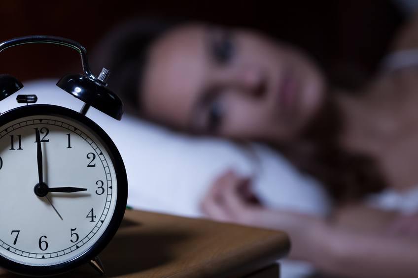 Alarm clock on bed side table