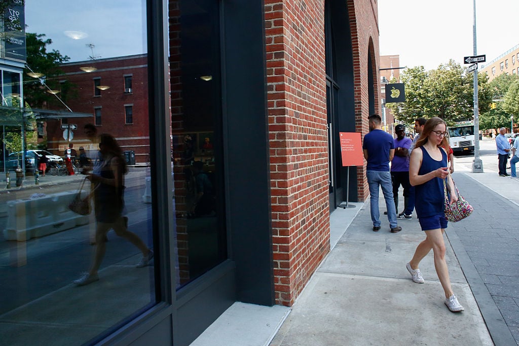 A woman walks by the new Brooklyn Apple