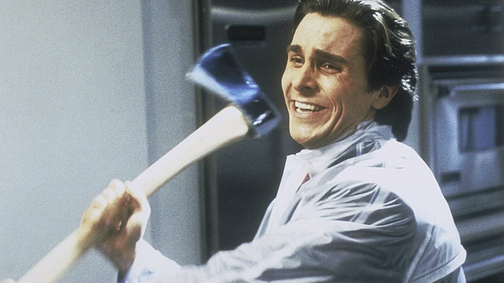 Christian Bale as Patrick Bateman in American Psycho is swinging an axe.