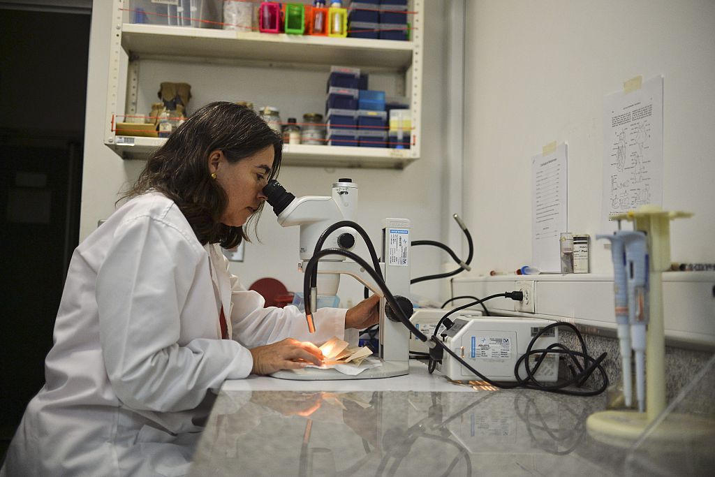 scientist at microscope