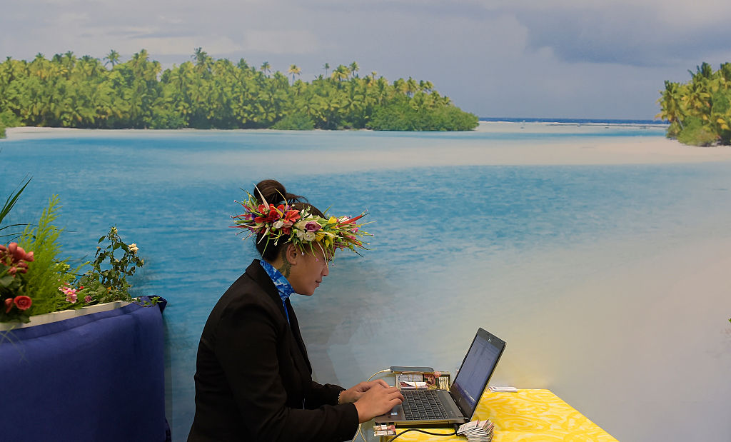 A fair hostess uses laptop at booth