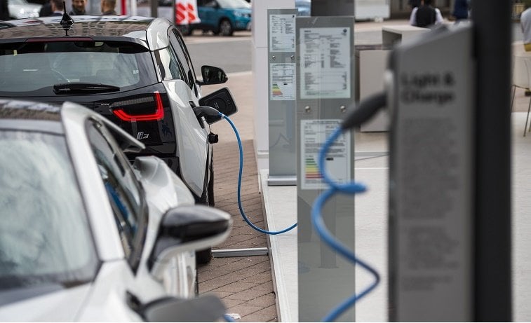 The electric powered BMW i8 (L) and i3 (behind) are seen next to a charging point at the 66th IAA auto show in Frankfurt am Main, western Germany, on September 15, 2015.