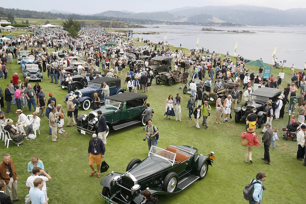 Cars line the 18th fairway at the Pebble Beach Concours