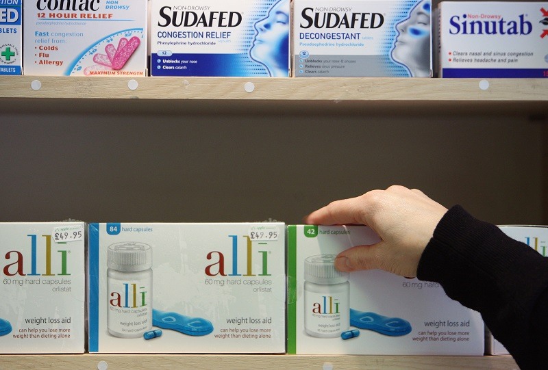 Alli slimming pill is displayed for sale Alli slimming pill is displayed for sale