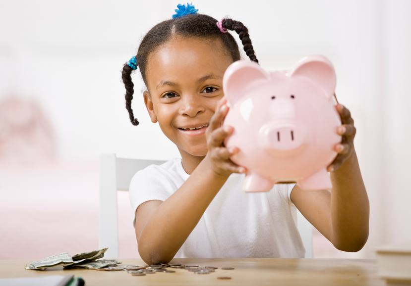 girl holding piggy bank