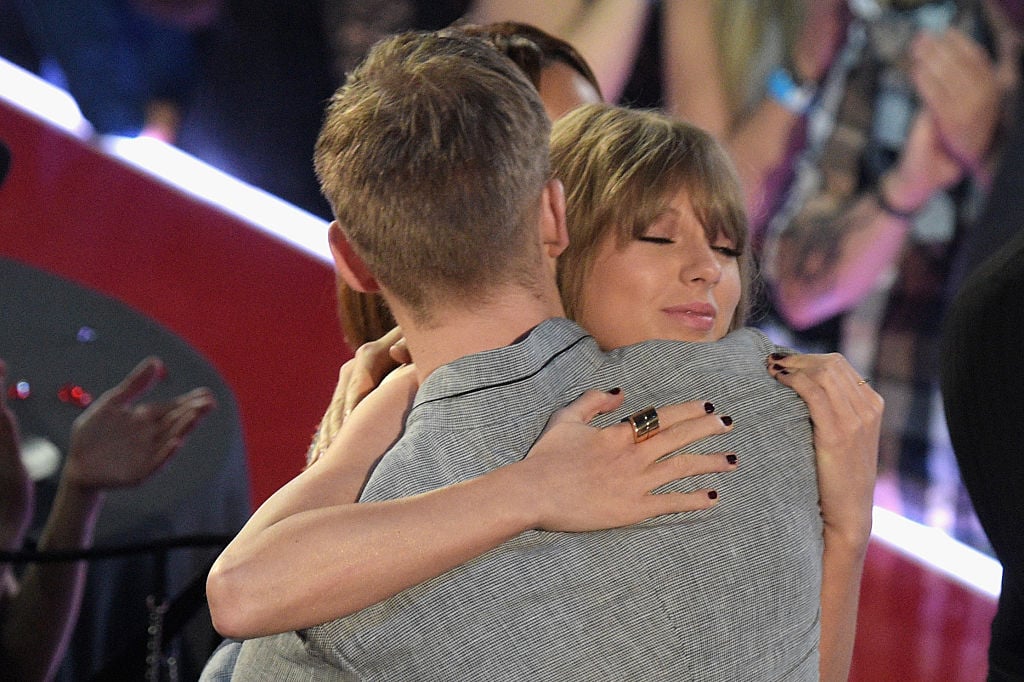 Taylor Swift hugs Calvin Harris at an awards show. 