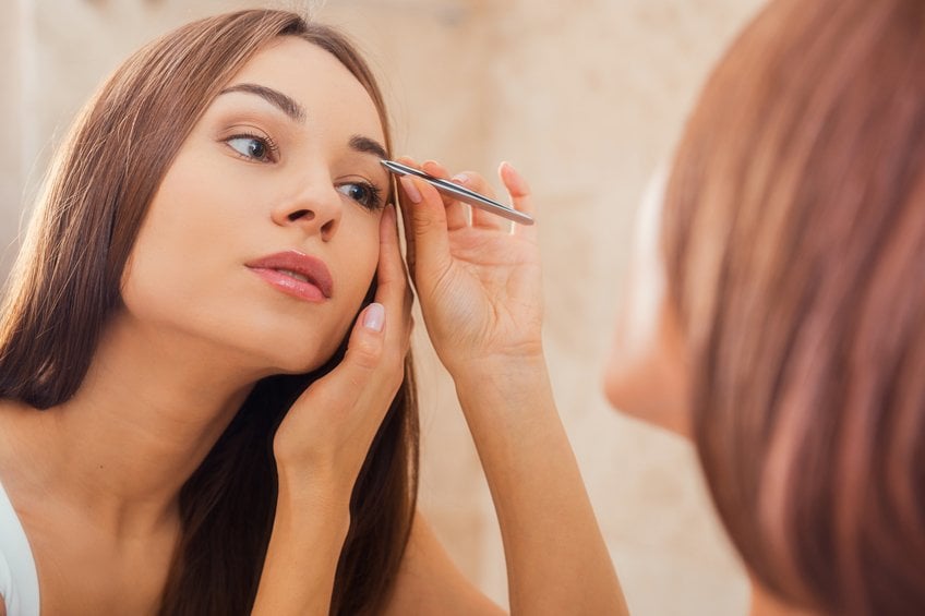 Tweezing eyebrows