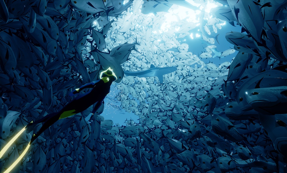 A diver swims into a school of fish in the game Abzu