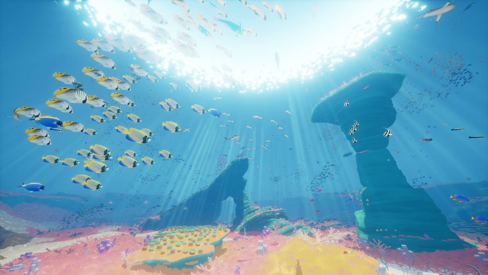 Fish swim in a colorful underwater environment.