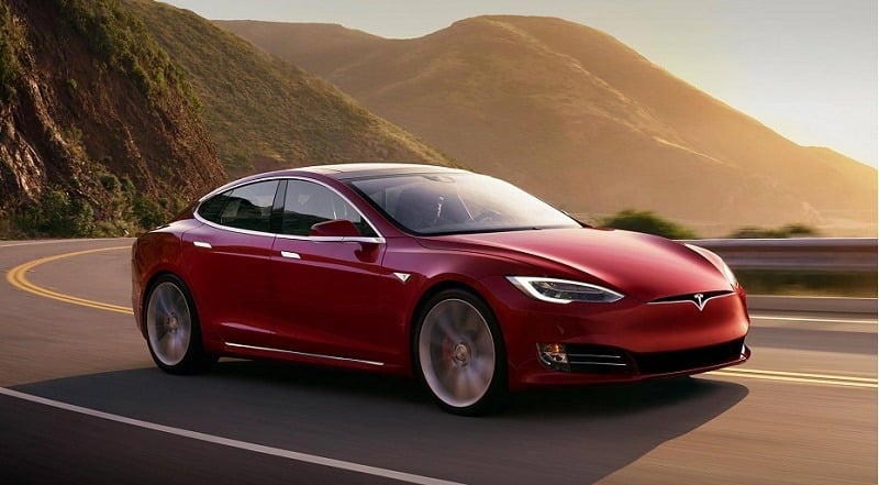 Road view of Tesla Model S P100D at sunset
