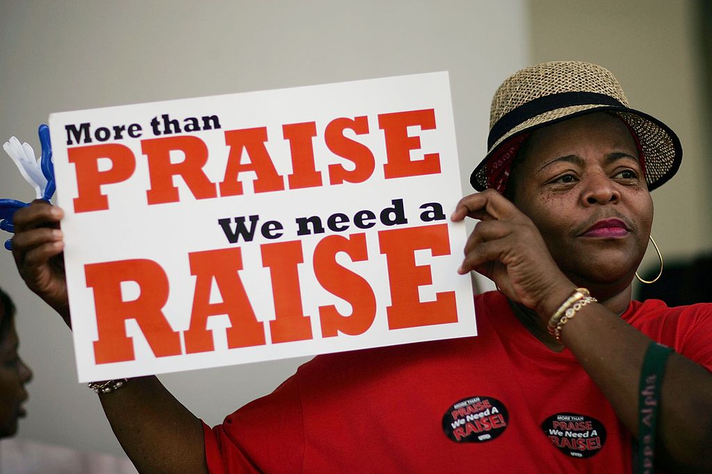 teacher protesting for a pay raise