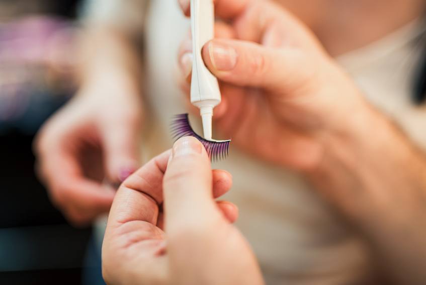 Close-up of a woman preparing false eyelashes
