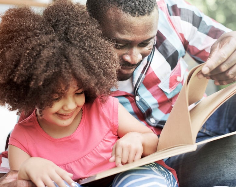 Father and daughter reading a book