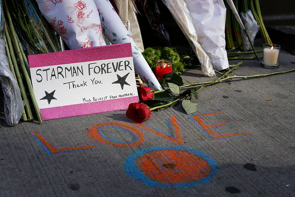 A memorial outside David Bowie's house with flowers and cards