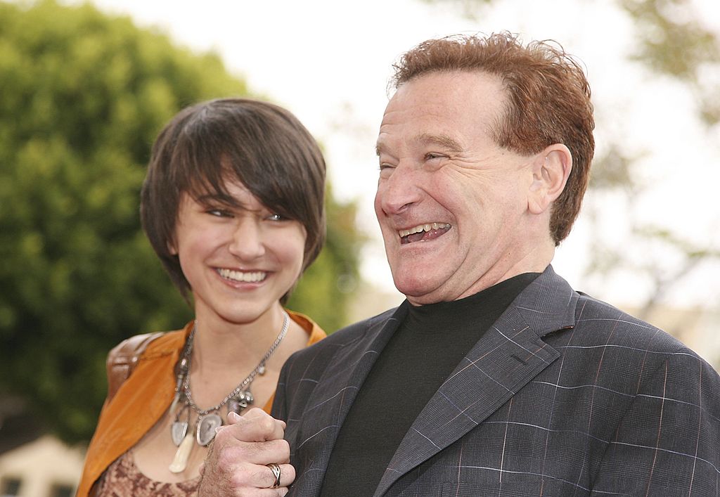 Robin Williams and his daughter Zalda holding hands and laughing
