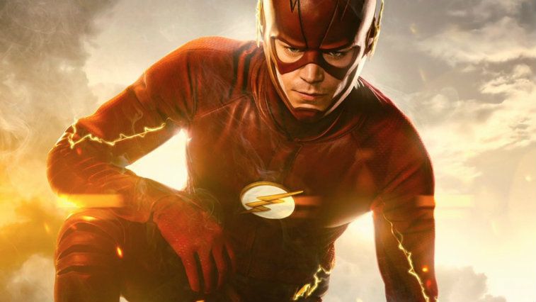Grant Gustin wears his red suit while running against a cloudy sky in The Flash
