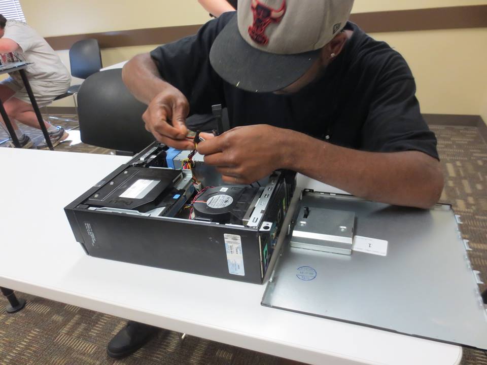 An ITT Tech student works on computer hardware