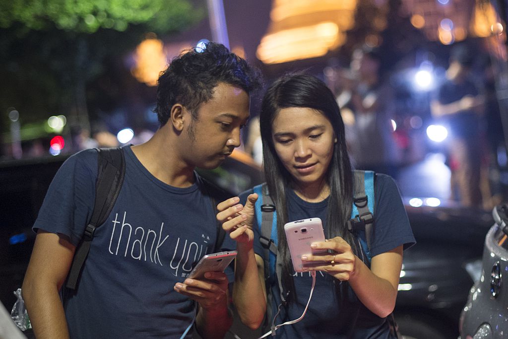 residents of Yangon gather in the street near the city hall to play Pokemon Go