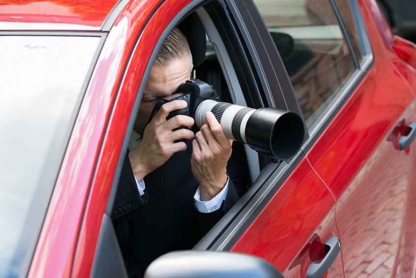 Male photographer in a car