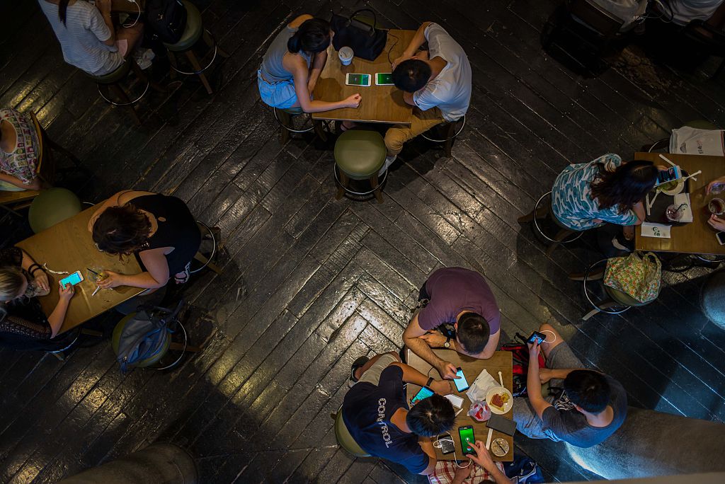 People play Pokemon Go on their smartphones