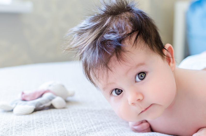 newborn baby girl looking with big beautiful hazel brown eyes